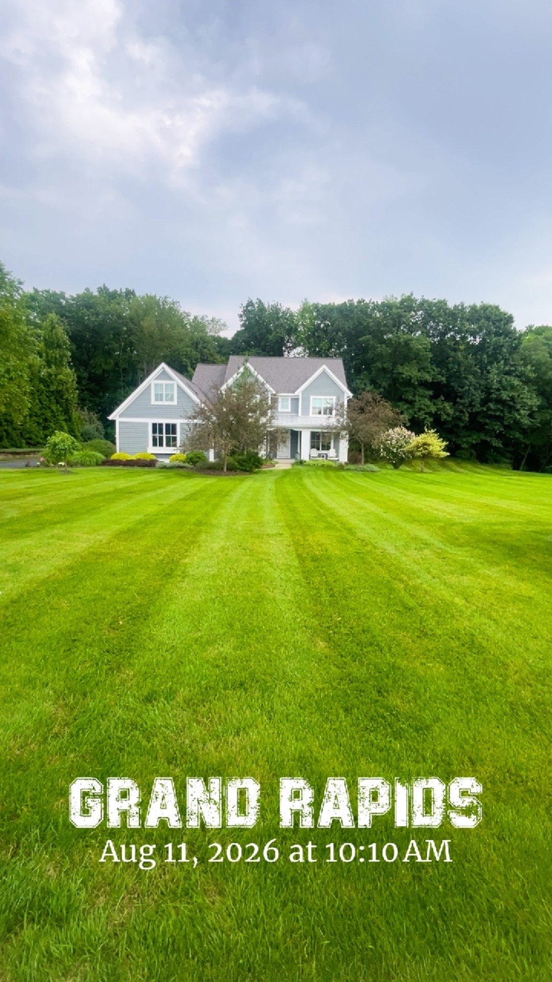 Large residential lawn with freshly cut mowing stripes